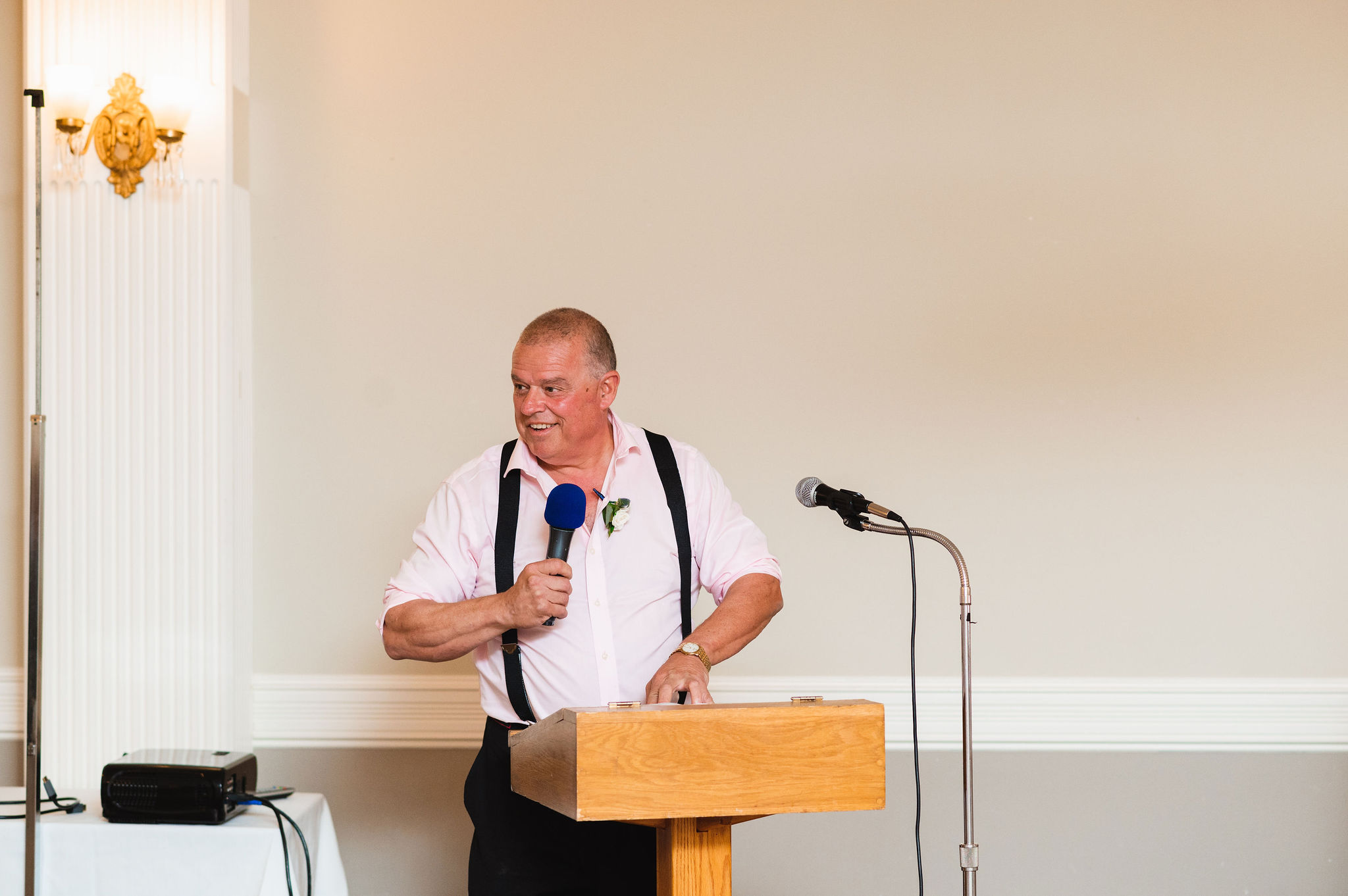 father of the bride reading his speech into a microphone during a special wedding reception at the Royal Ashburn in Pickering