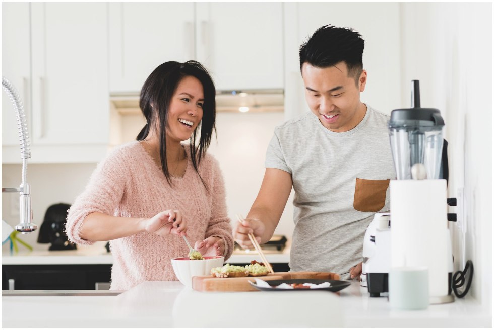 Couple making lunch during their Toronto lifestyle maternity photos. 