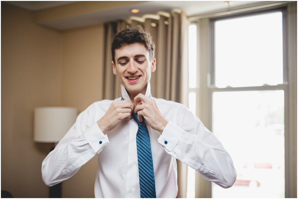 Groom tying his tie