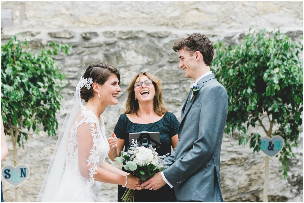 Bride and groom holding hands during the Goldie Mill Ruins wedding ceremony