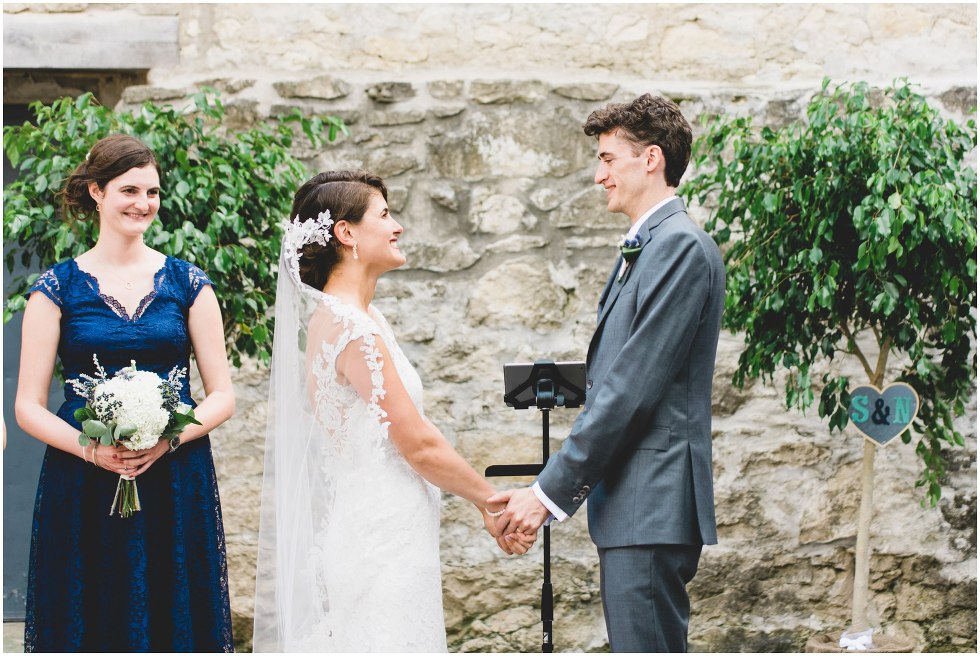 Bride and groom smiling during the Goldie Mill Ruins wedding ceremony
