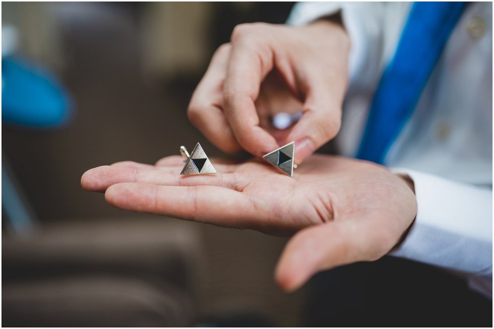 Groomsmen holding cufflinks in his hand 