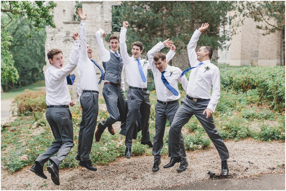 Groomsmen jumping up high together