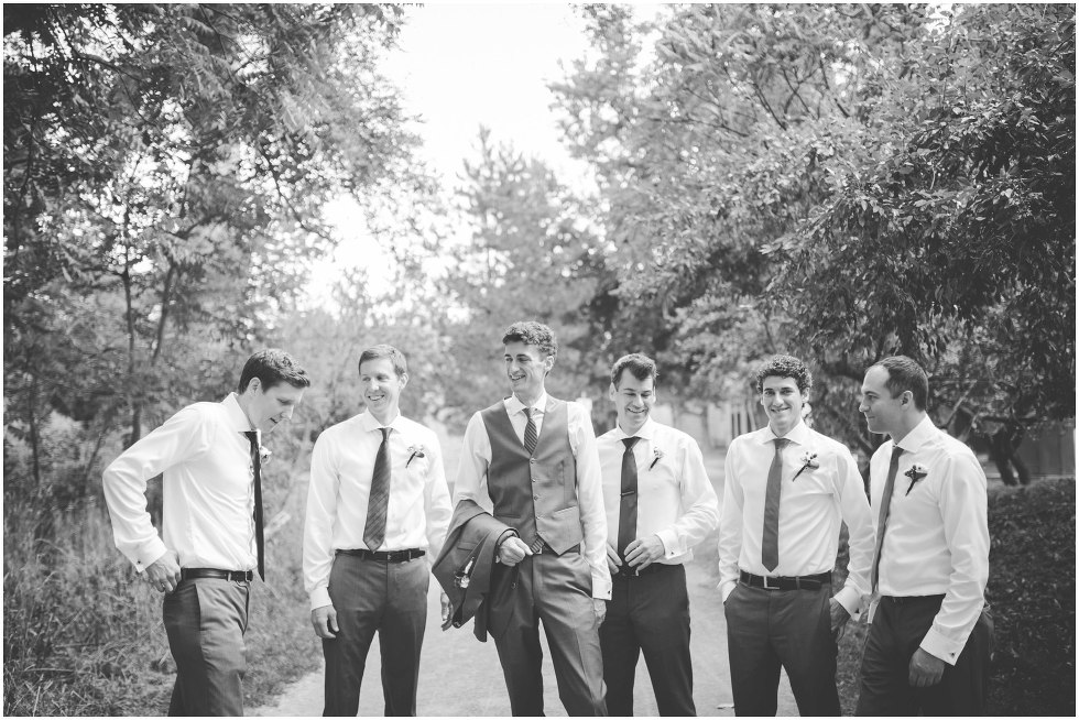 Groom and groomsmen laughing and smiling together at Goldie Mill Ruins