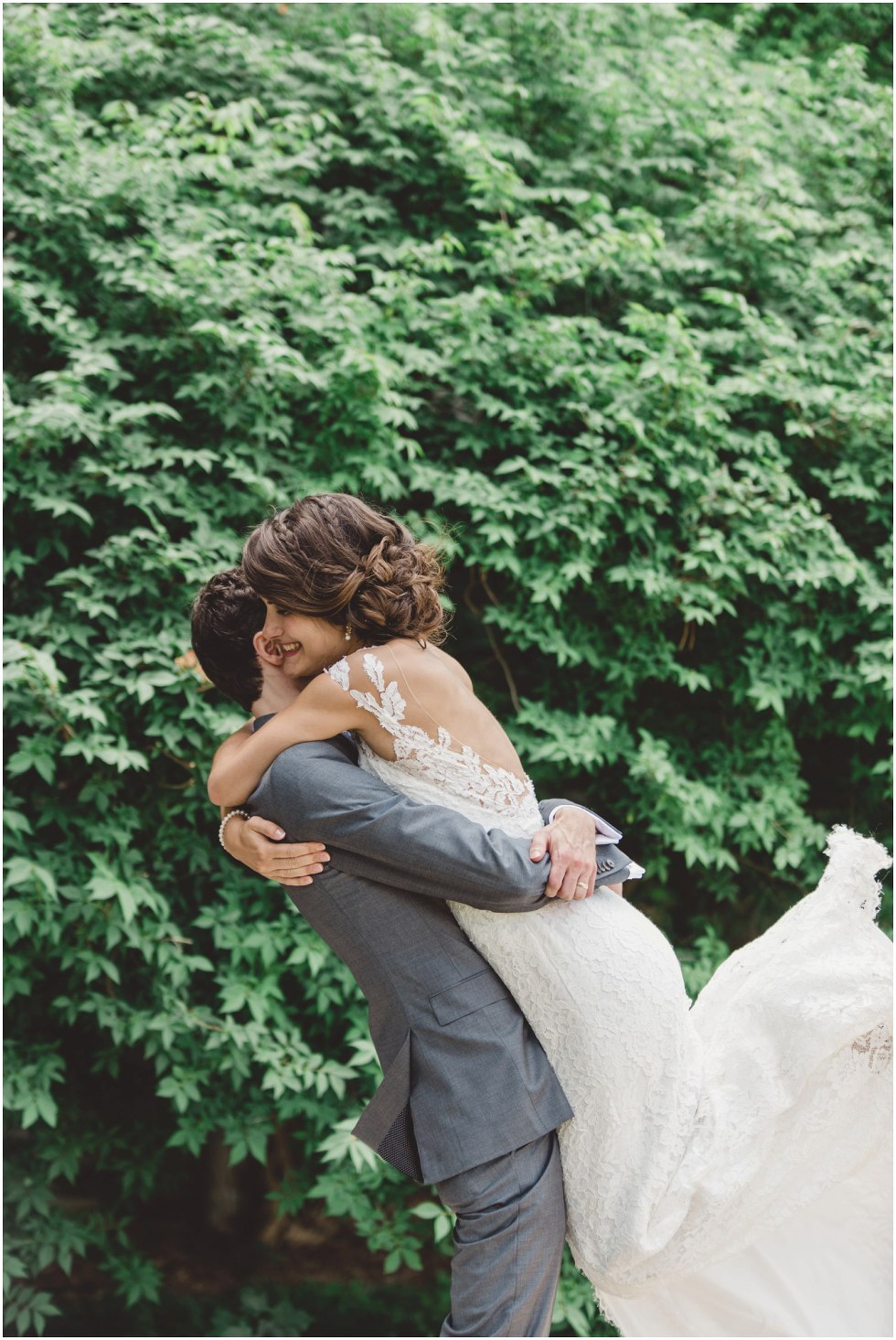 Groom giving bride a very big hug during their first look 