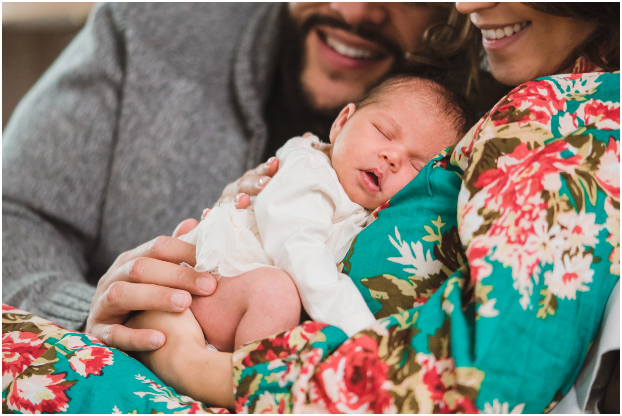 mother and father lying together on bed with hands resting on baby sleeping on mothers chest Gillian Foster family lifestyle photography Toronto