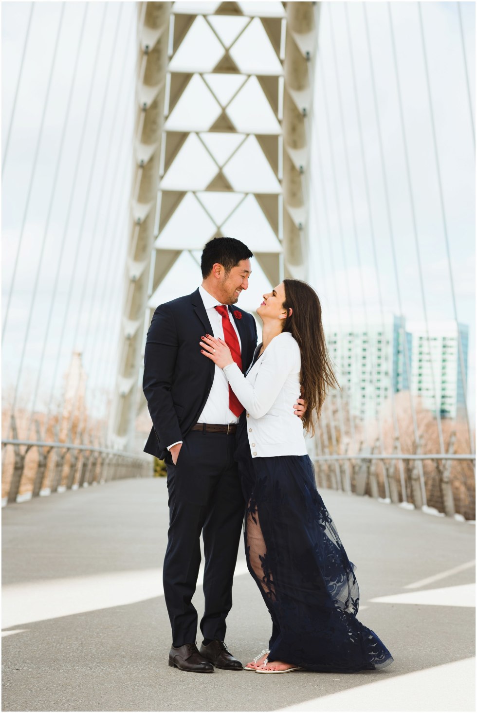 couple standing on white bridge with arms around each other Toronto Gillian Foster photography