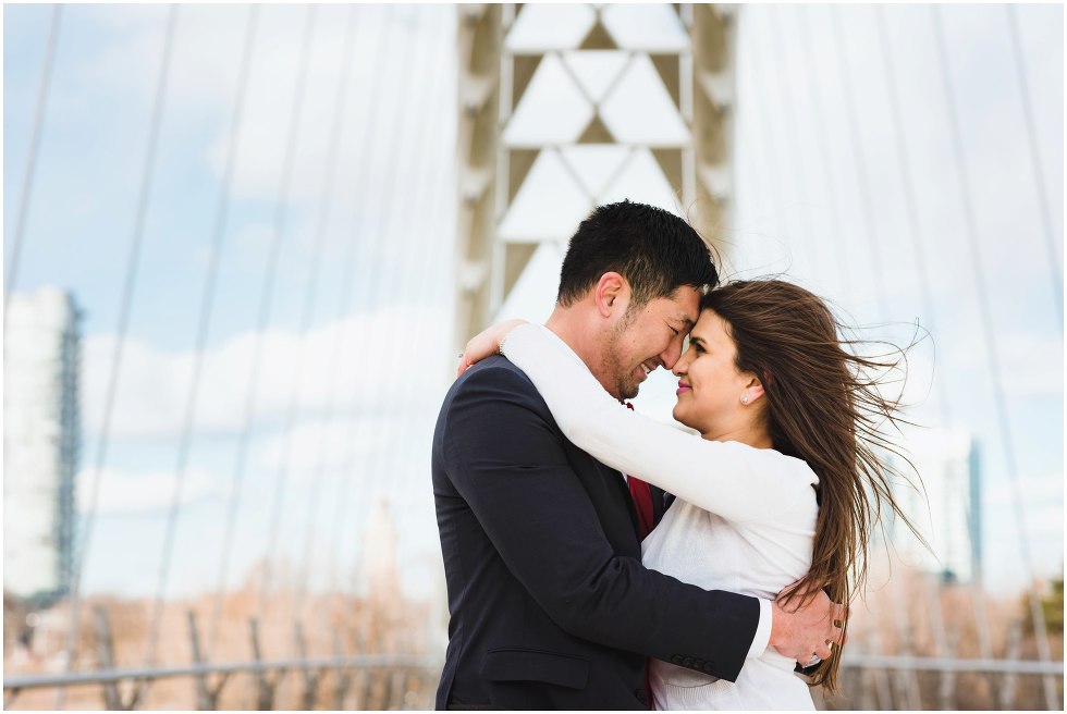 couple in loving embrace on white bridge Toronto proposal photography