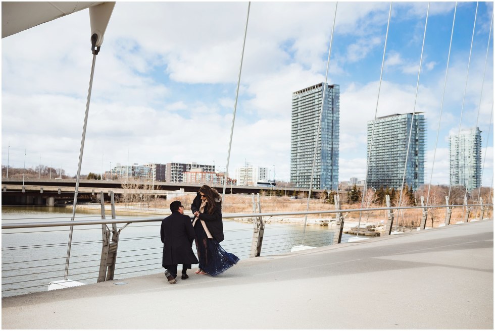 man proposing to woman on white bridge Toronto