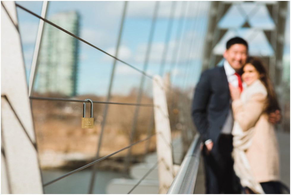 lock placed on bride railing with couple looking on Toronto proposal photographer Gillian Foster