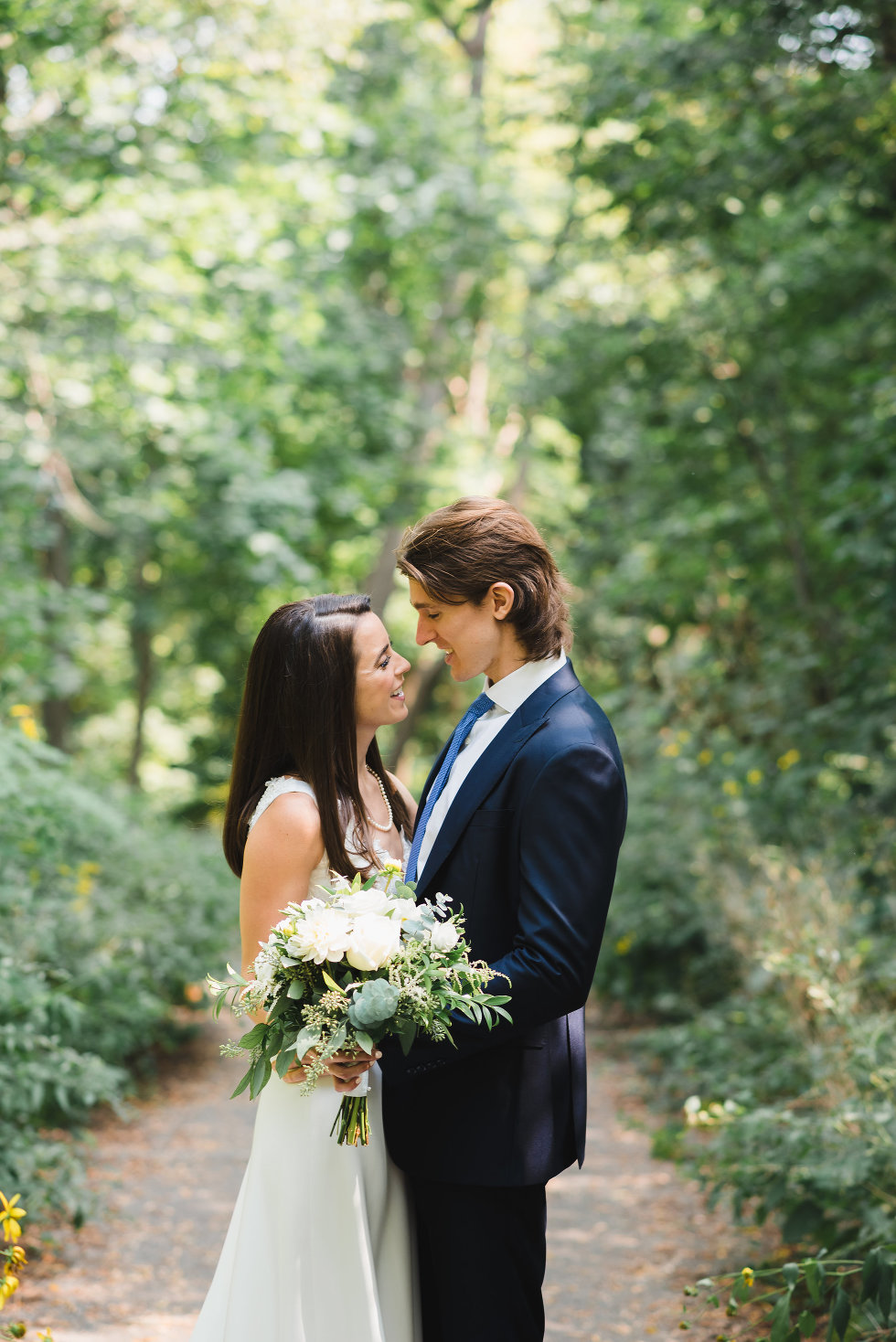 bride and groom in loving embrace surrounded by forest Toronto wedding photography