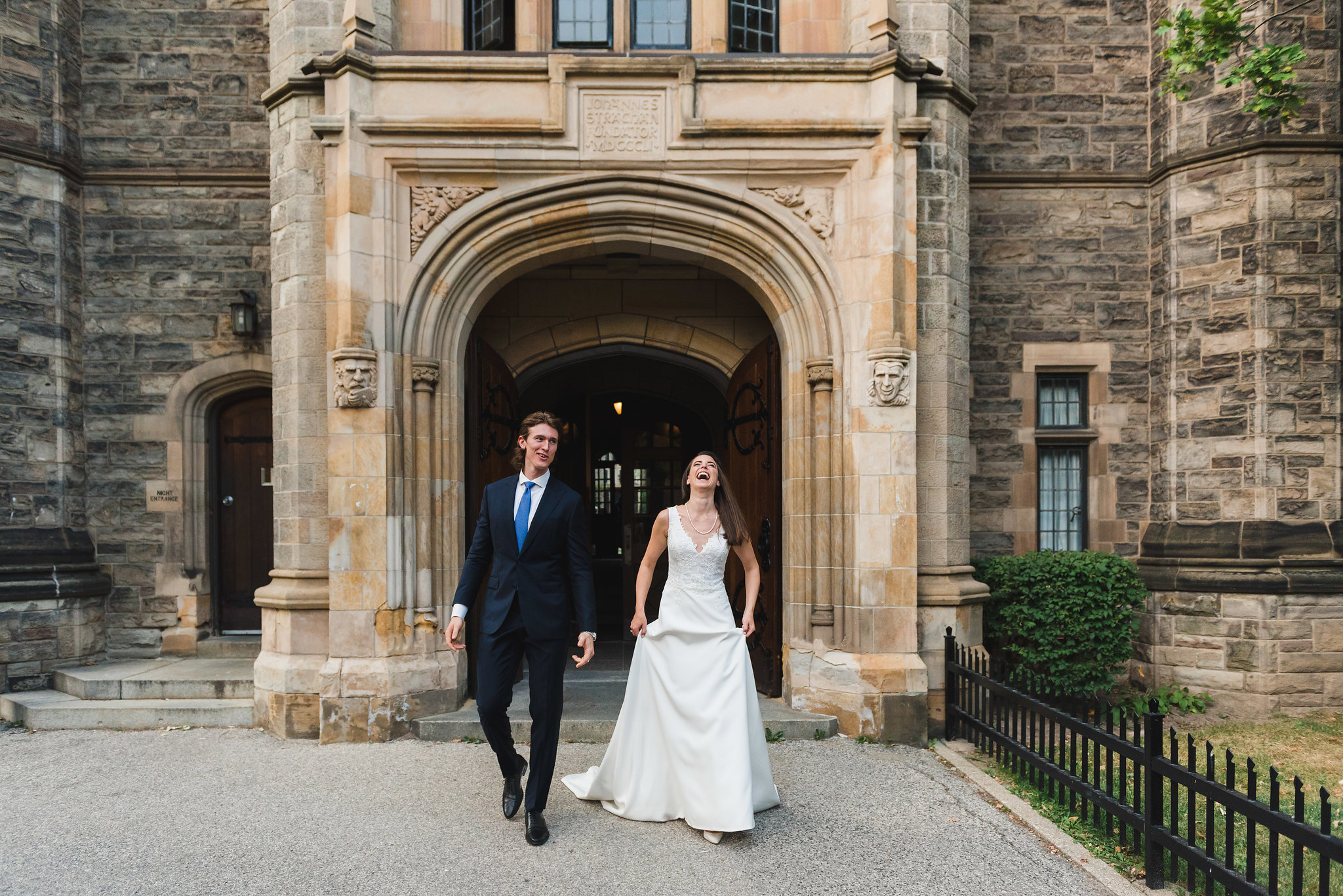 bride and groom exit church, bride laughs Toronto wedding photography