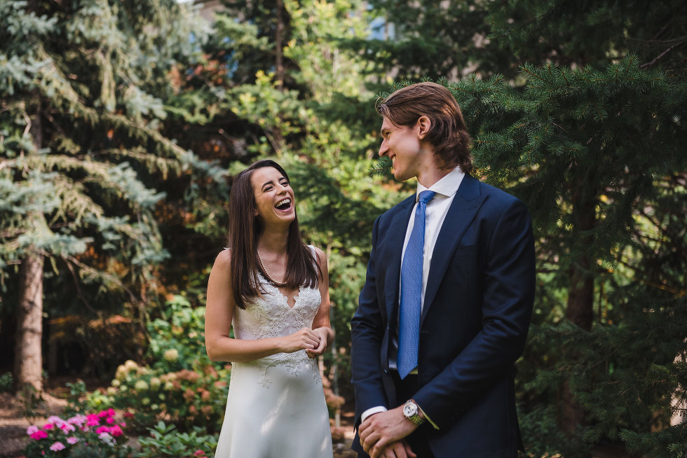 bride and groom smiling at each other surrounded by trees and garden Toronto wedding photography