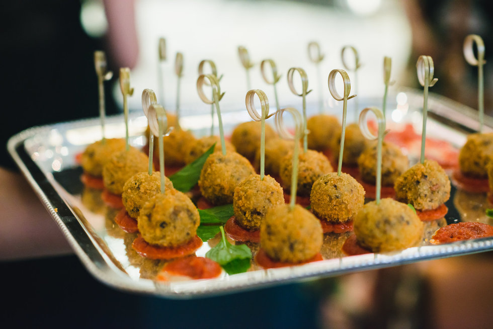 silver tray holding appetizers with skewers stuck into top of them Toronto wedding photography
