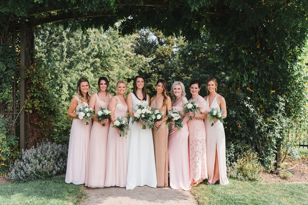 bride and her bridesmaids in a line holding bouquets Toronto wedding photography