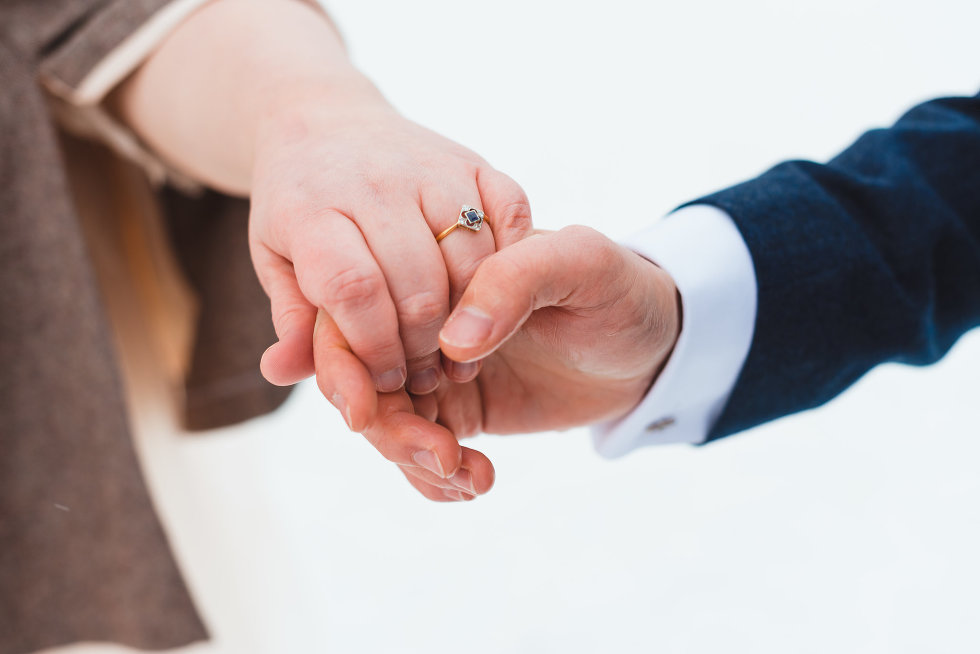 bride and groom holding hands, blue sapphire ring Niagara wedding photography Gillian Foster