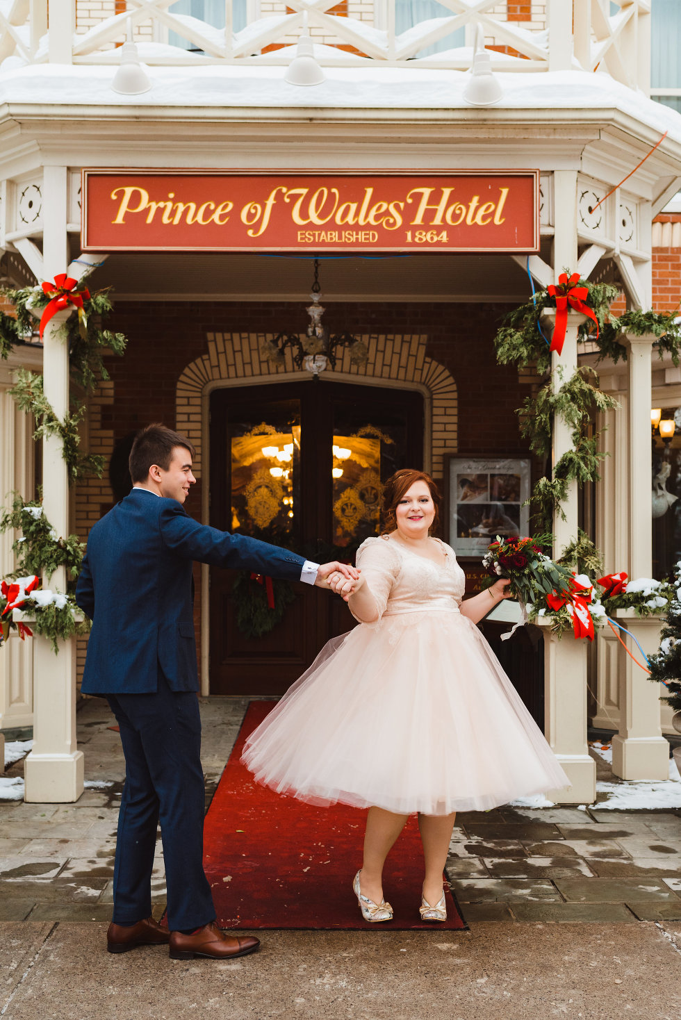 groom spins bride outside of Prince of Wales Hotel Niagara wedding