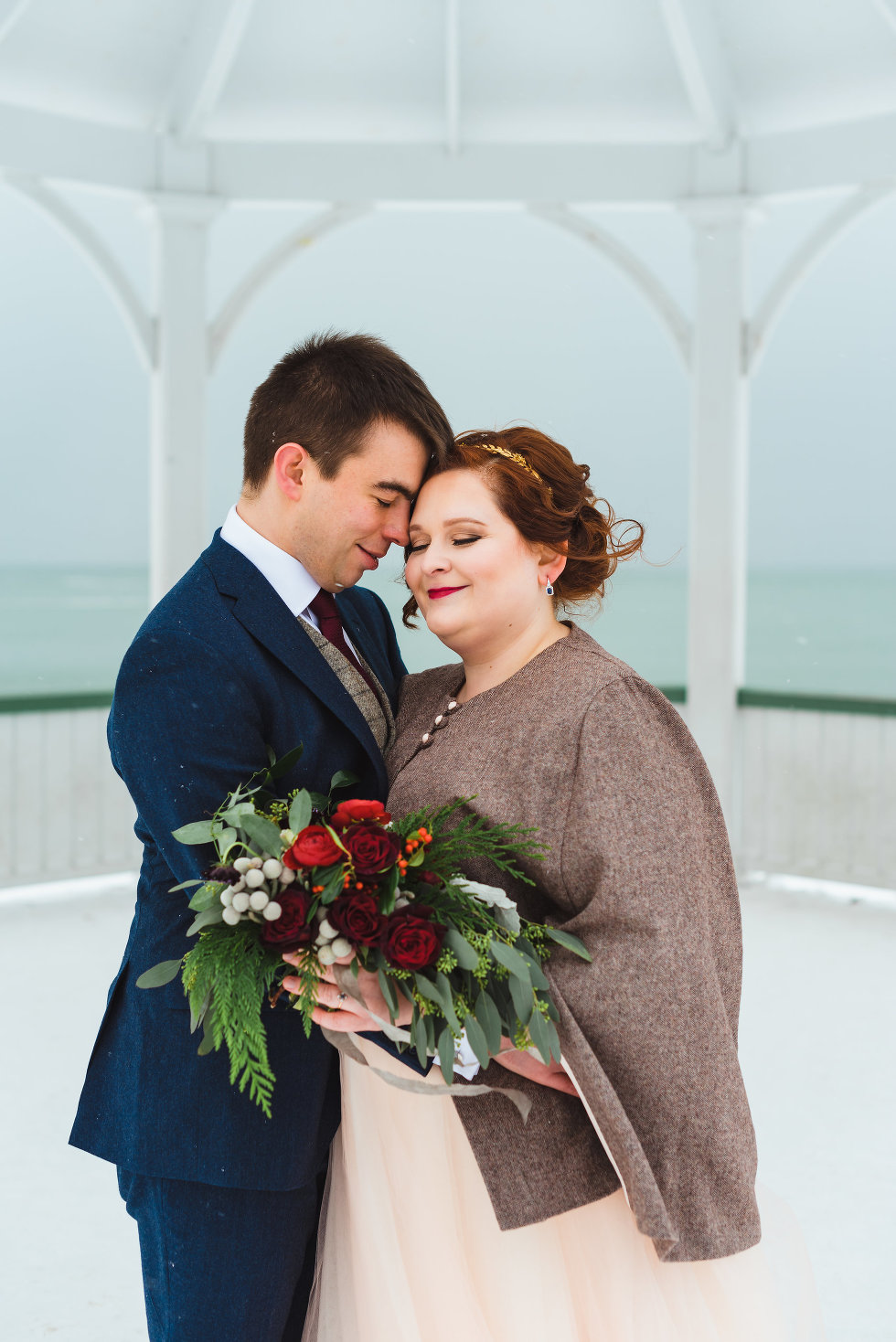 bride and groom in loving embrace in front of white gazebo Niagara wedding photography