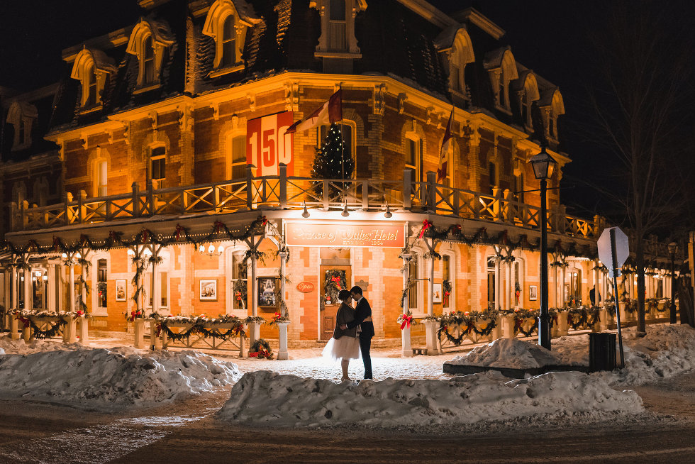 bride and groom stand together in front of the Prince of Wales Hotel Niagara wedding photography Gillian Foster 