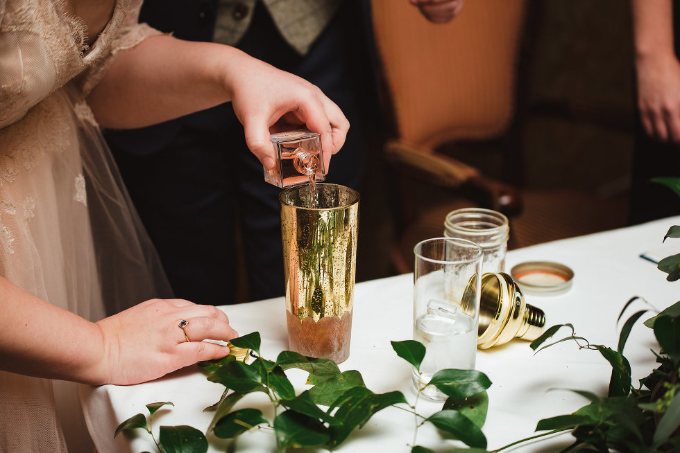 bride pours bottle of gin into cocktail shaker Prince of Wales Hotel wedding