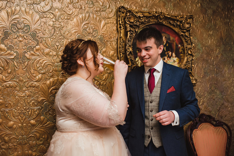 groom watches bride while she takes a sip of a cocktail Prince of Wales Hotel Niagara wedding photography