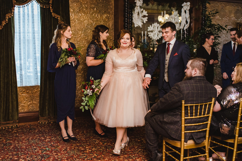 bride and groom exit past wedding guests after ceremony Niagara wedding photography