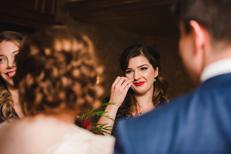 bridesmaid wiping away a tear during wedding ceremony Niagara wedding photography