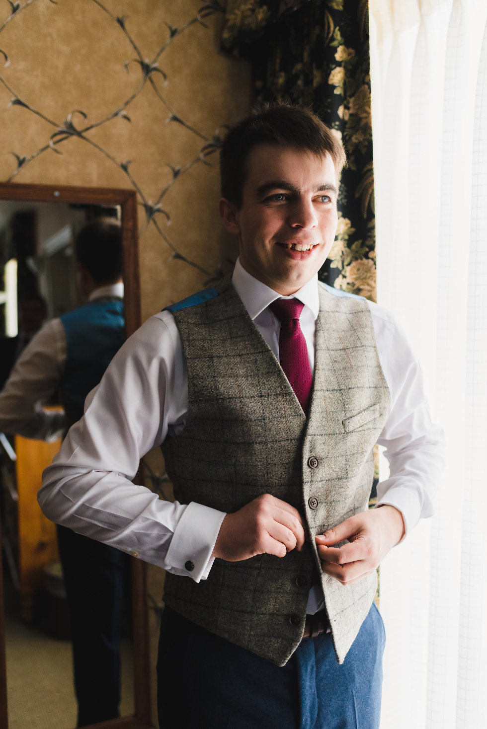 groom buttons up green tweed vest over white shirt and burgundy necktie Niagara wedding photography Gillian Foster