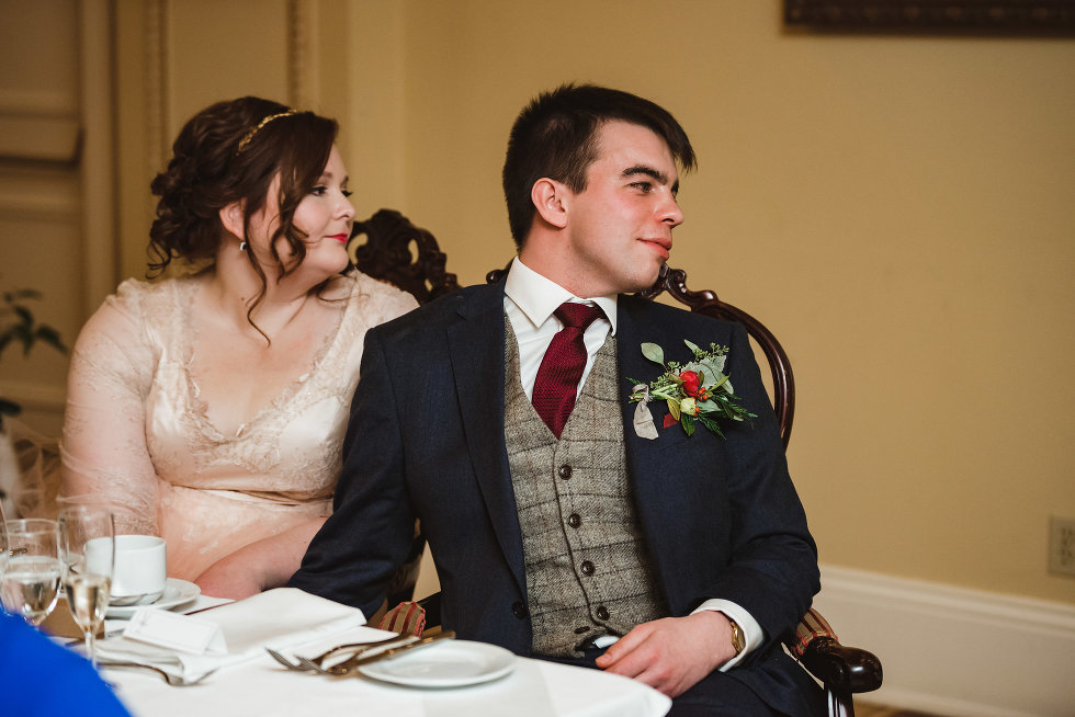 bride and groom seated at head table listening to speeches at the Prince of Wales Hotel Niagara wedding photography Gillian Foster