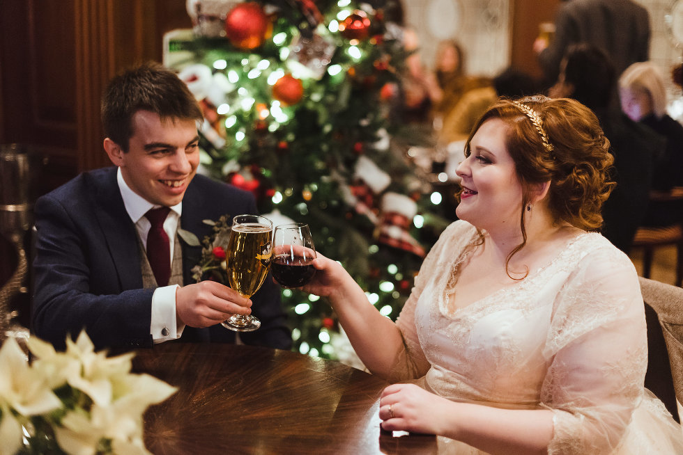 bride and groom seated for reception white toasting with their drinks Prince of Wales Hotel Niagara wedding photography