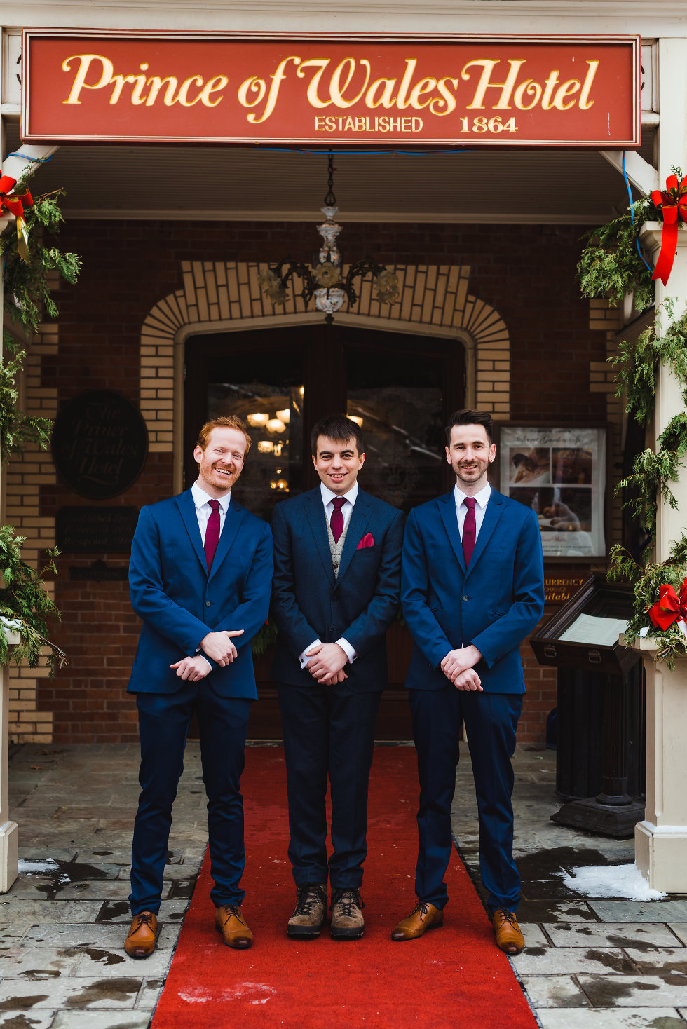 groom and groomsmen stand before the Prince of Wales Hotel Niagara wedding photography