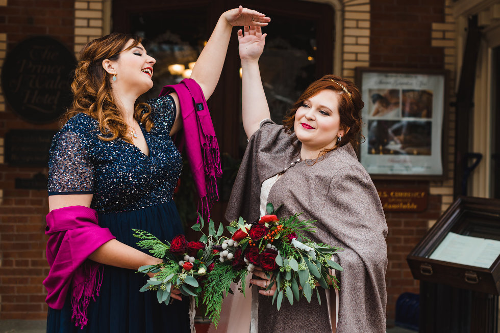 bride and bridesmaid doing pirouette with hands up Niagara wedding