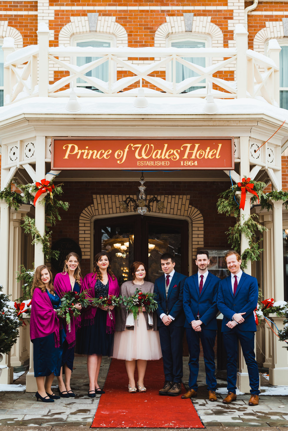 bride and groom with their wedding party outside Prince of Wales Hotel Niagara wedding