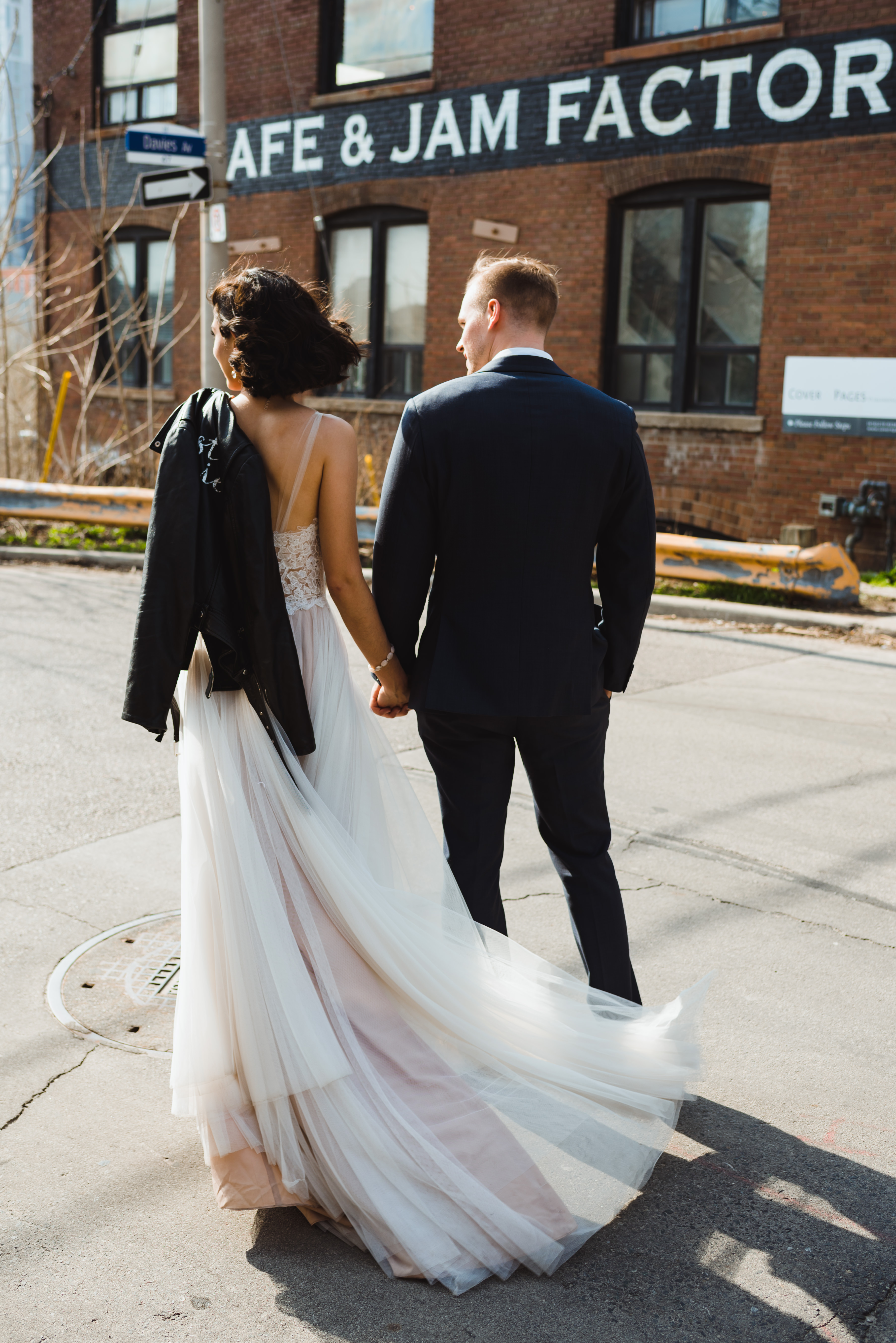 bride and groom crossing street in front of the Jam Factory, Toronto wedding photography Gillian Foster