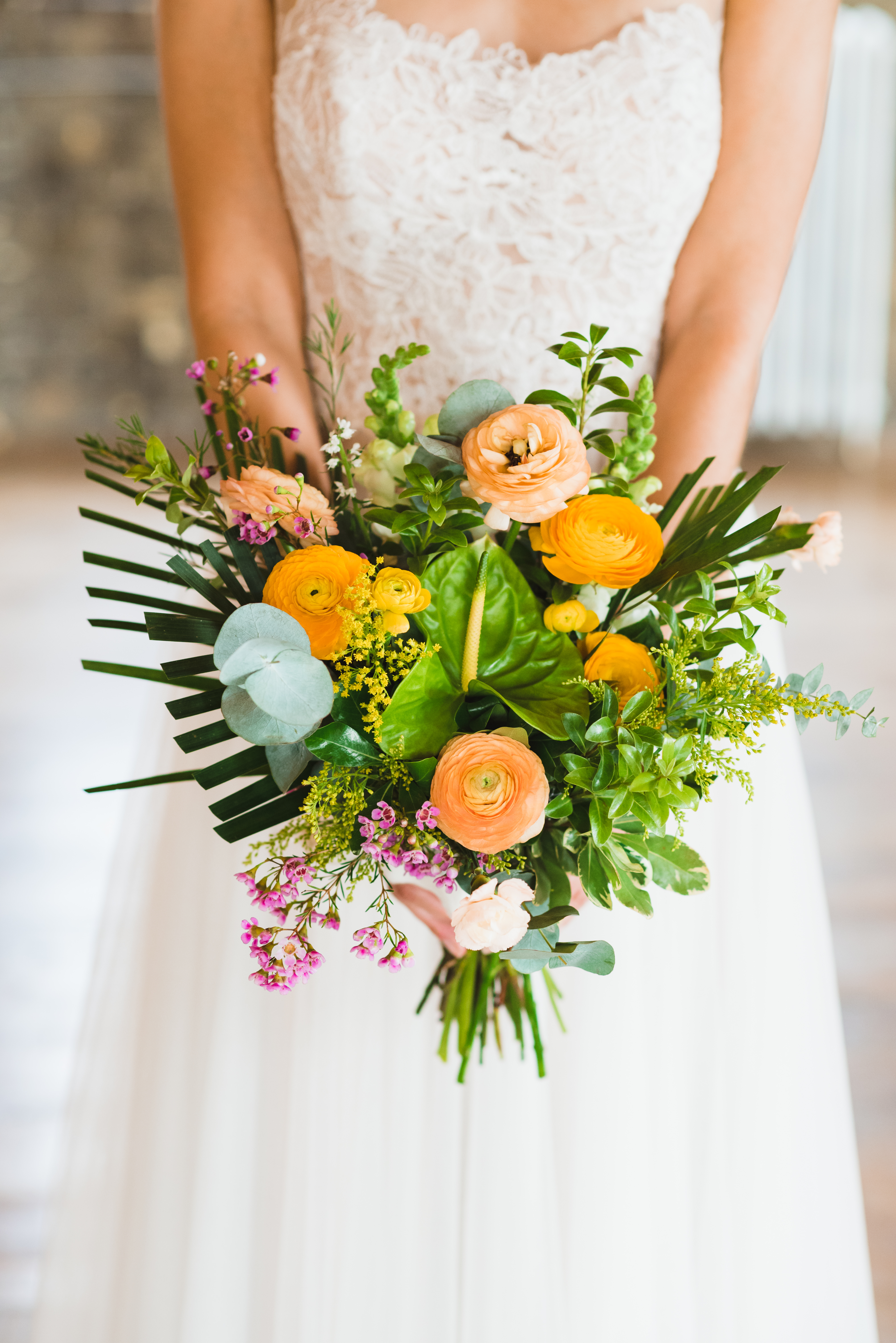 bride holding floral bouquet in front of her at the Jam Factory Toronto wedding photography