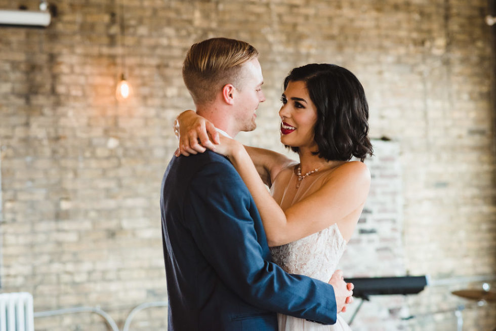 bride and groom with arms wrapped around each other inside Jam Factory Toronto wedding photography
