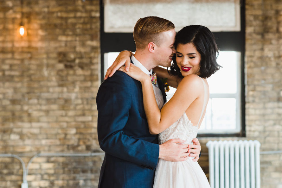 groom pressing his face up to brides face inside Jam Factory Toronto wedding photography