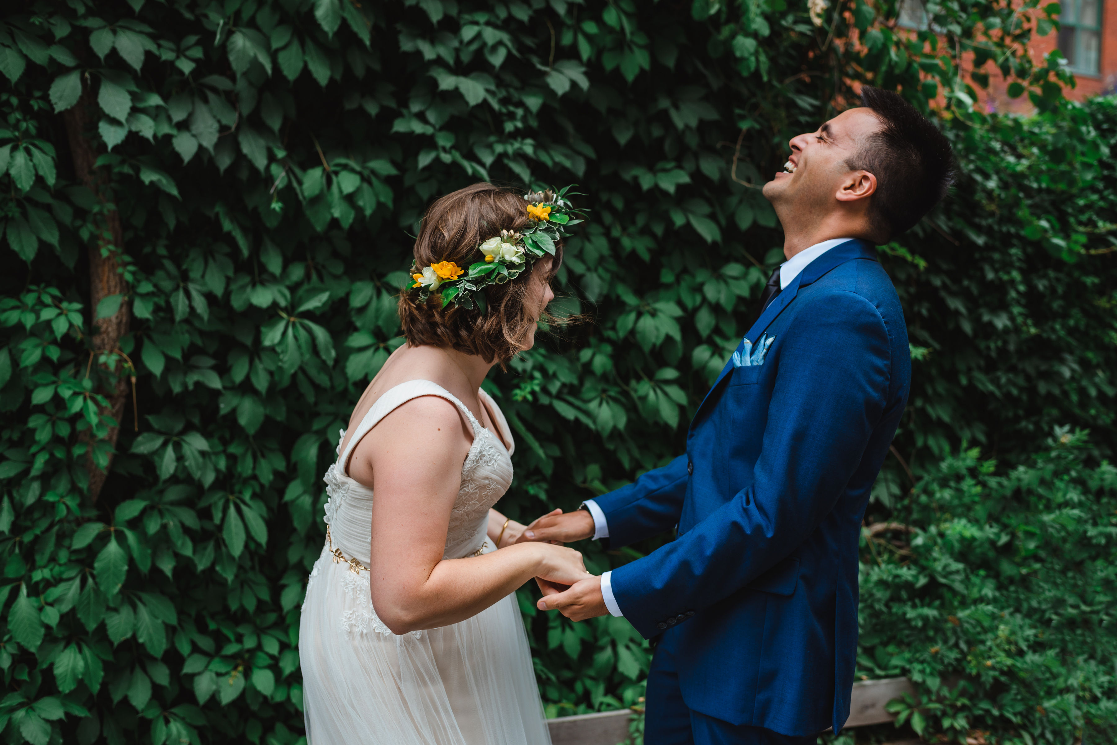 groom smiling as he reacts to first sight of his bride in her dress Toronto brewery wedding photography