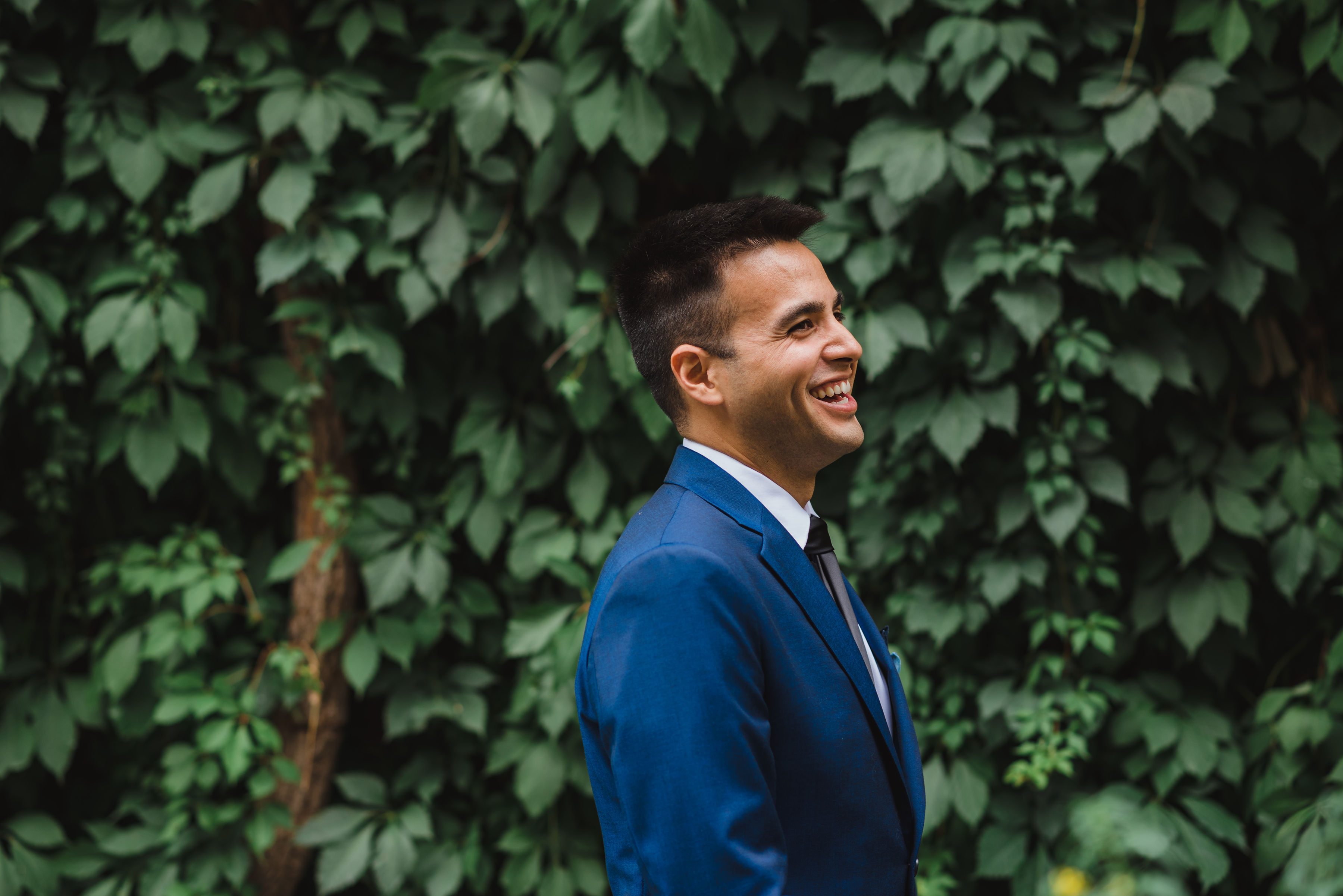 groom in blue suit smiling as he awaits his bride Toronto wedding photography