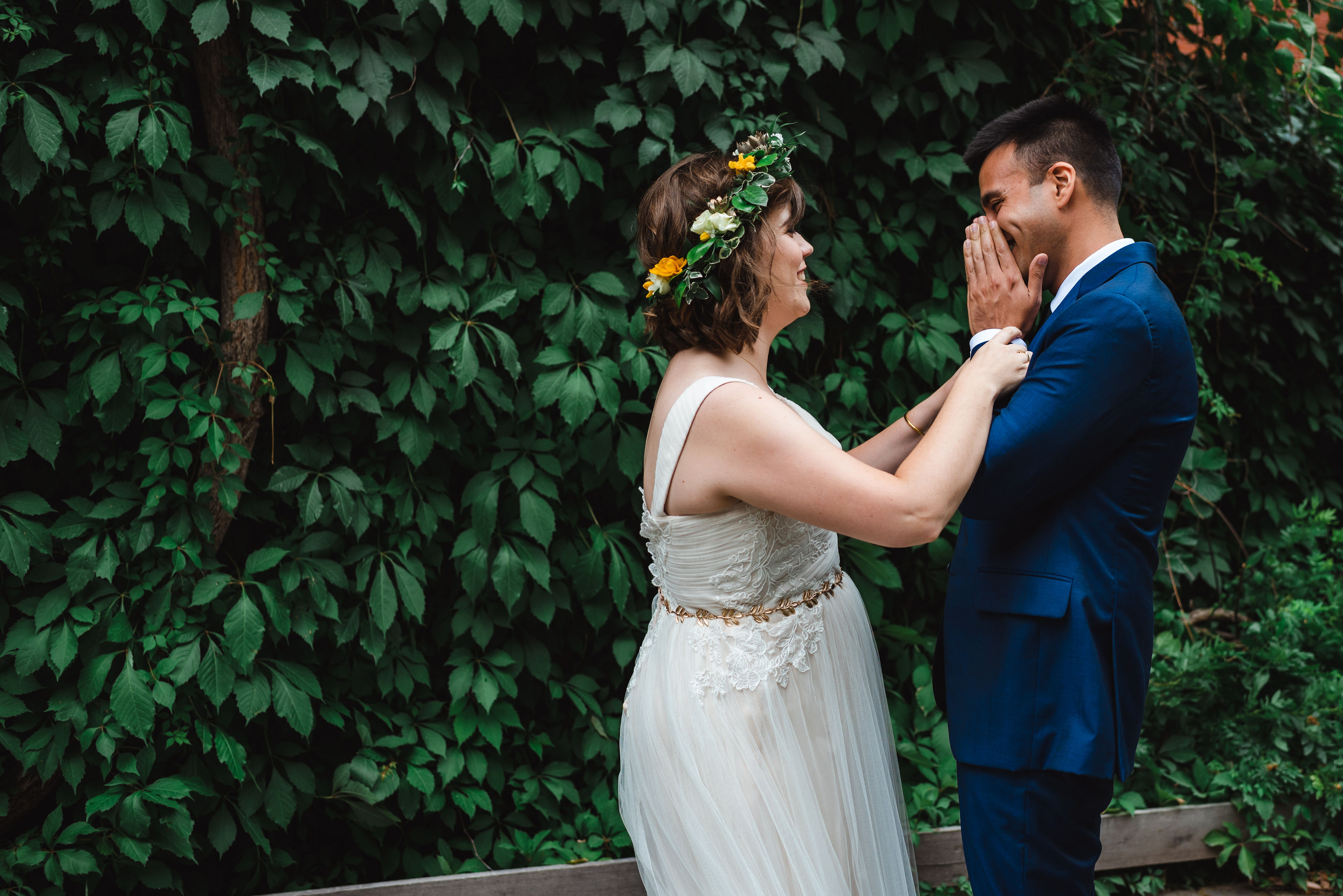 groom placing his hands over his smiling face reacts to first sight of his bride in her dress Toronto brewery wedding photography