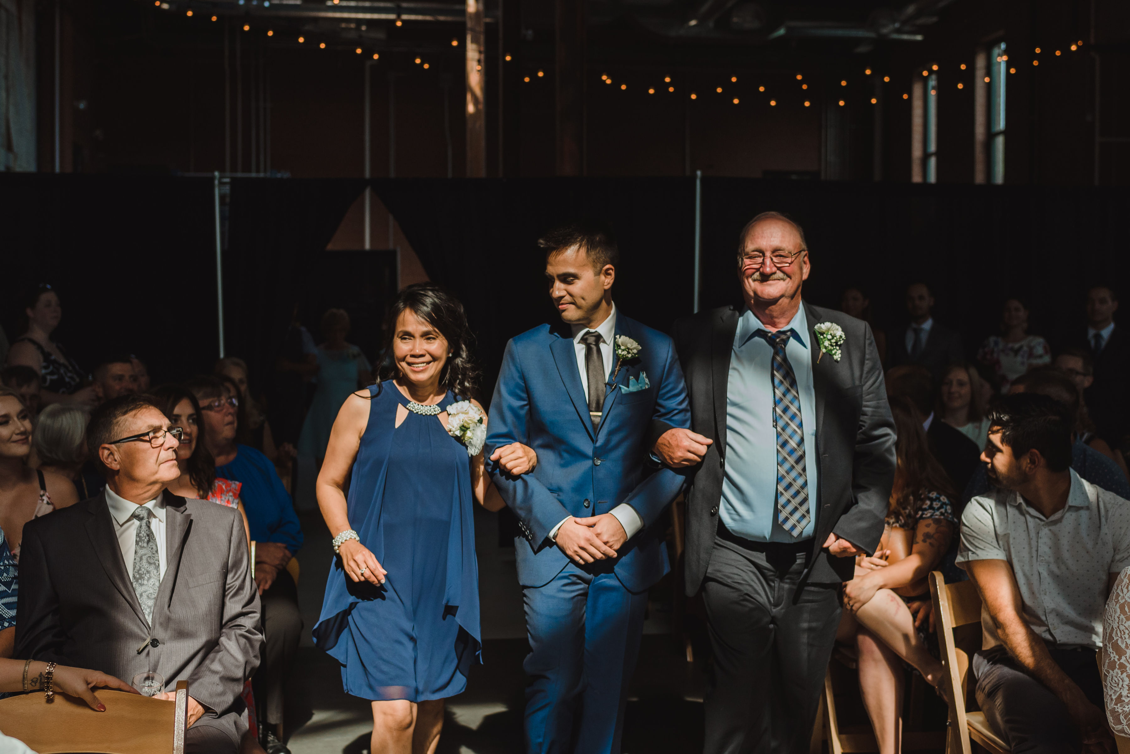 groom walking down the aisle with his parents Toronto Junction Craft Brewing wedding photography