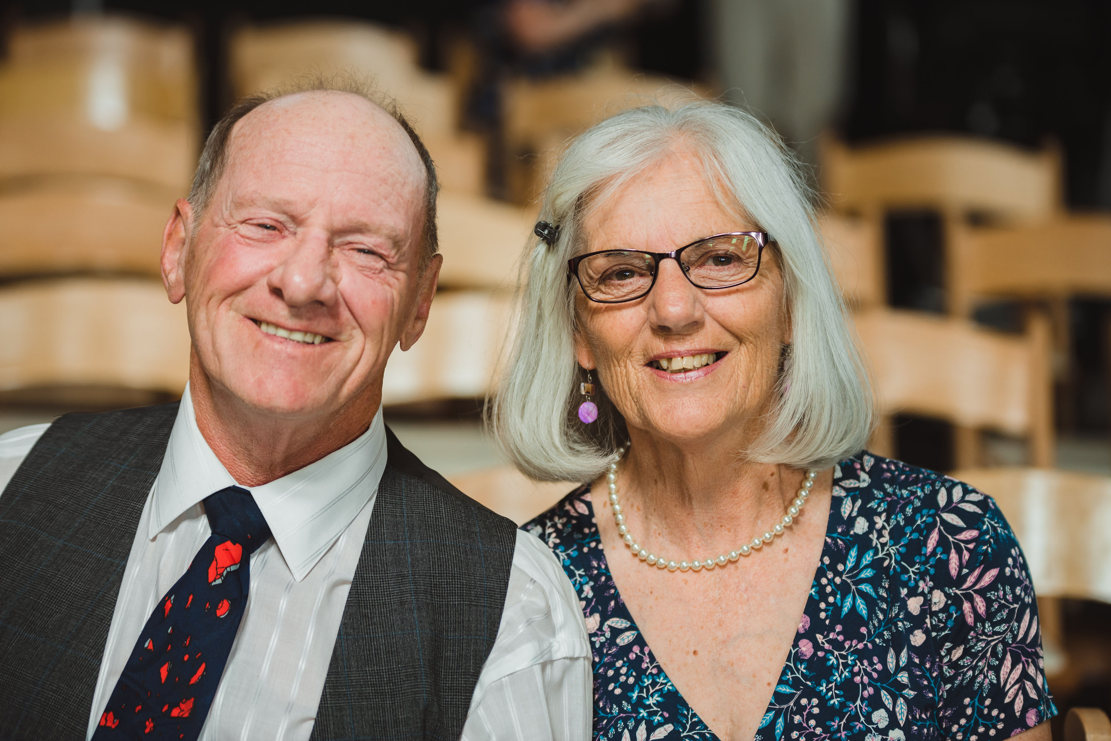 a man and woman smiling as they await a wedding ceremony Toronto Junction Craft Brewing wedding photography