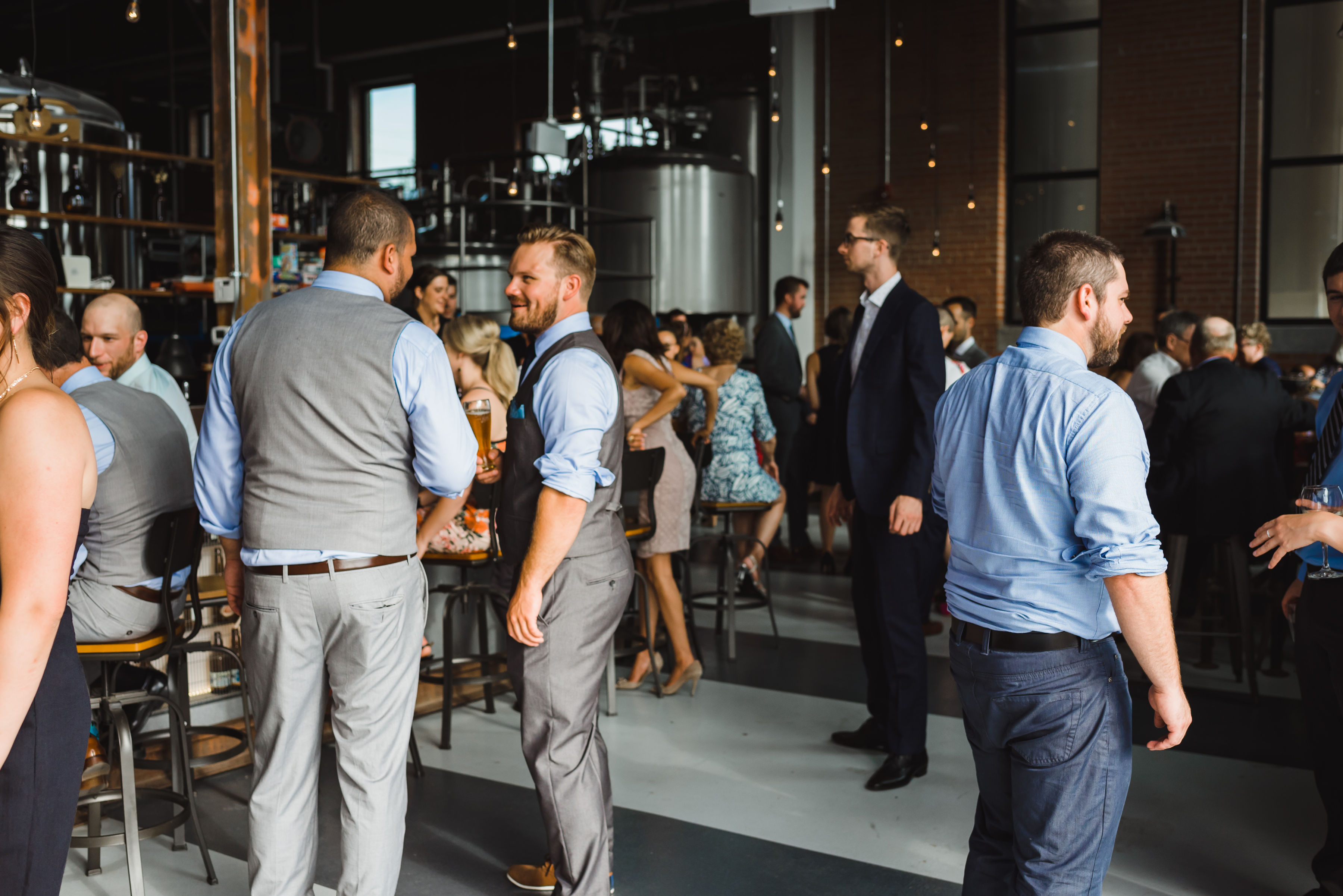 wedding wedding guests mingling at cocktail hour after wedding ceremony at Junction Craft Brewing Toronto wedding photography