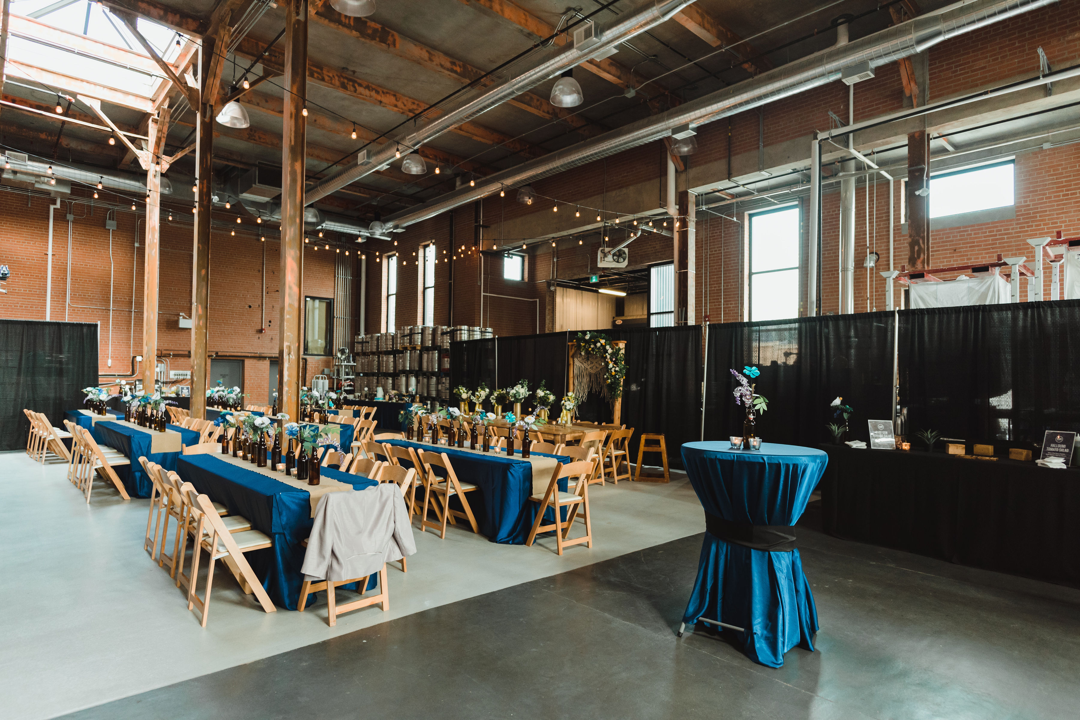 wedding reception tables set up in a craft brewery Toronto Junction Craft Brewing 