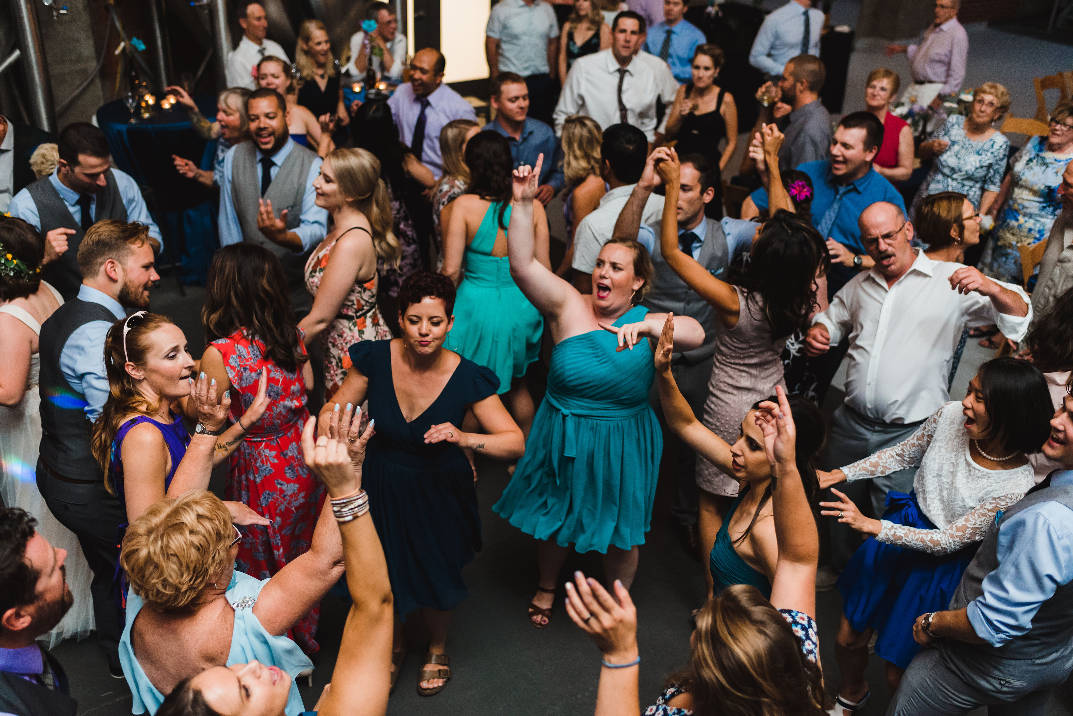 wedding guests dancing wildly on the dance floor Junction Craft Brewing Toronto wedding photography