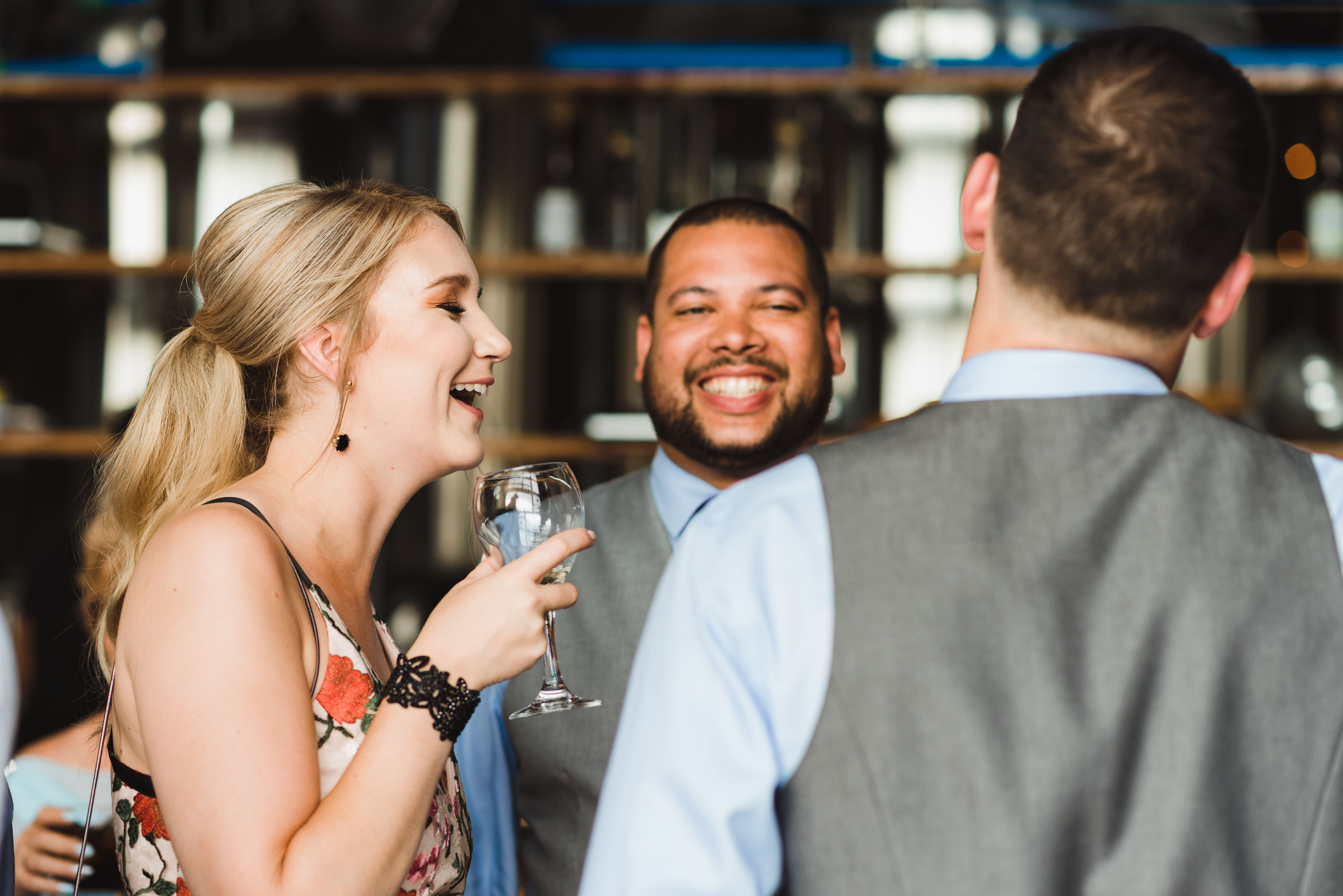 wedding guests laughing during cocktail hour after wedding ceremony at Junction Craft Brewing Toronto wedding photography