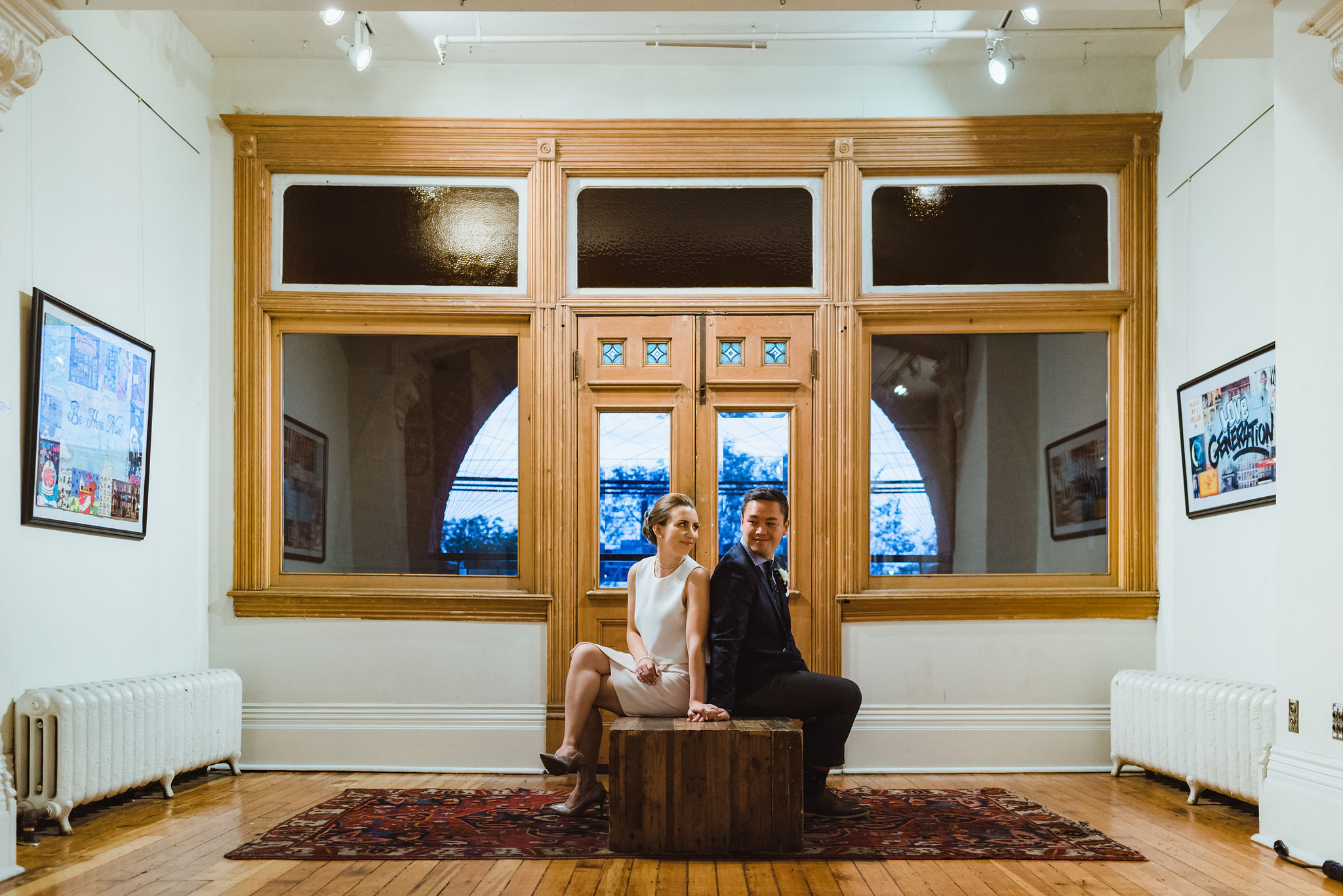 bride and groom sit with back to each other in the Gladstone Hotel in Toronto how to best plan your wonderful wedding your way