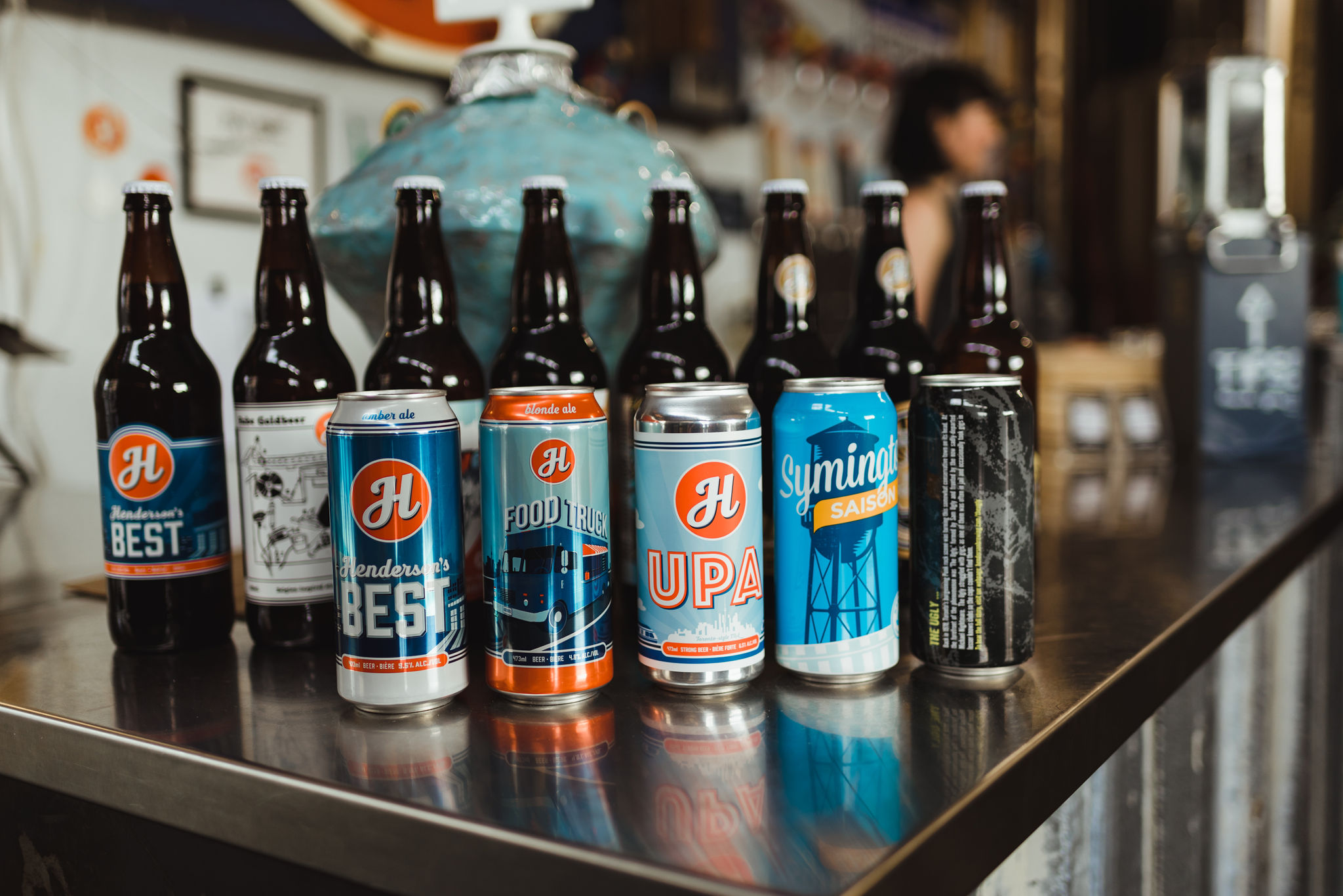 metallic bar with cans and bottles of Henderson Brewing Company beers on it Toronto wedding photography