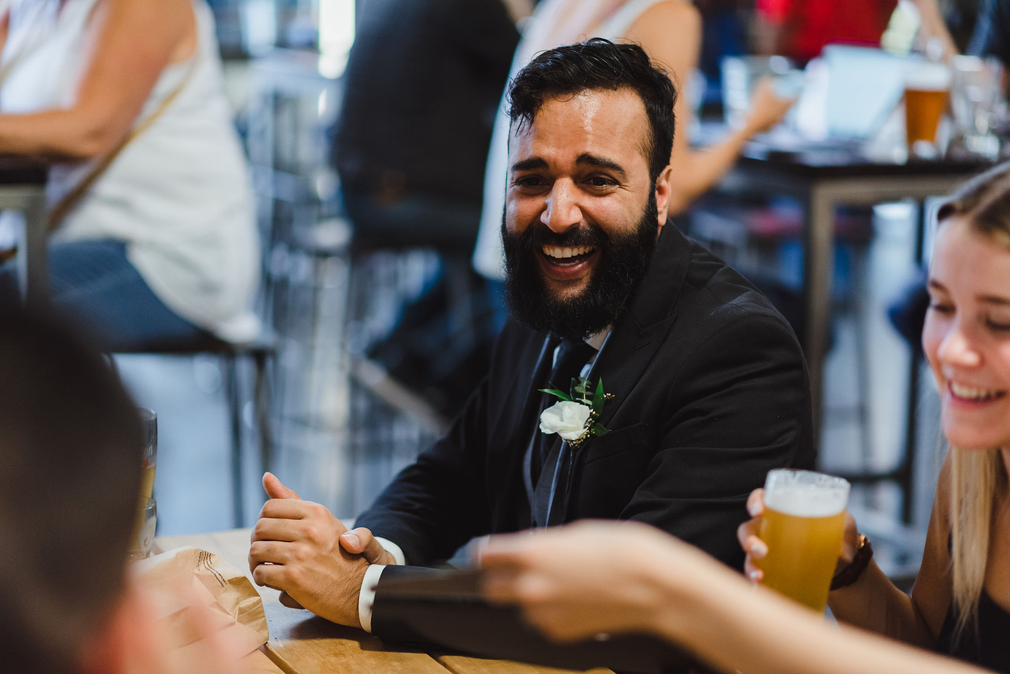 wedding guest laughing during cocktail hour at Henderson's Brewing Company Toronto wedding photography