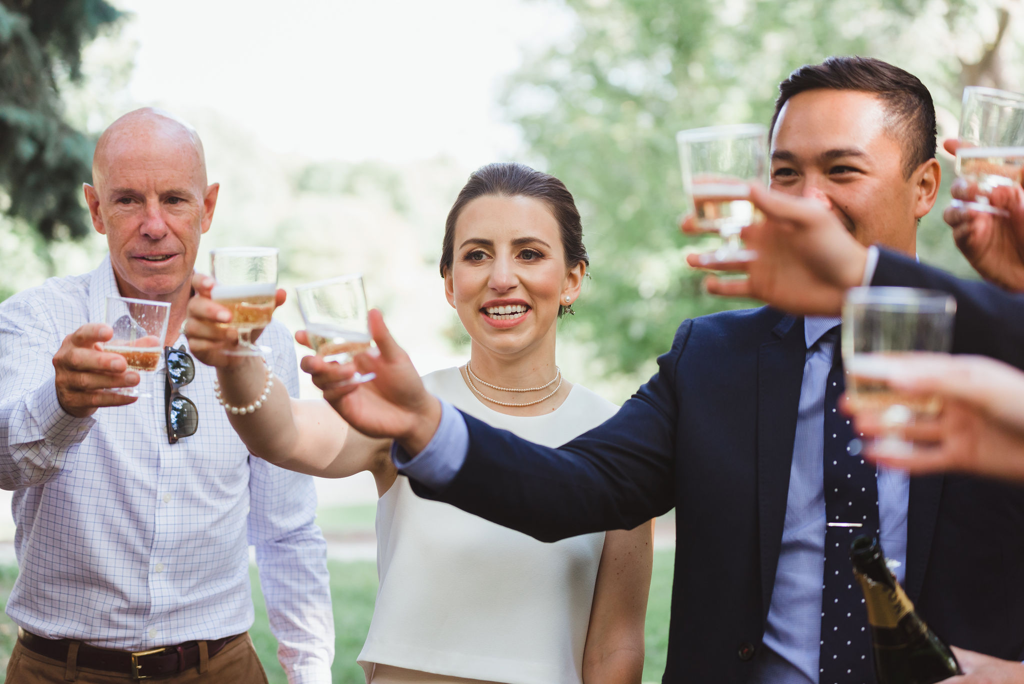 bride and groom toasting with the wedding guests after ceremony in Trinity Bellwoods Park Toronto